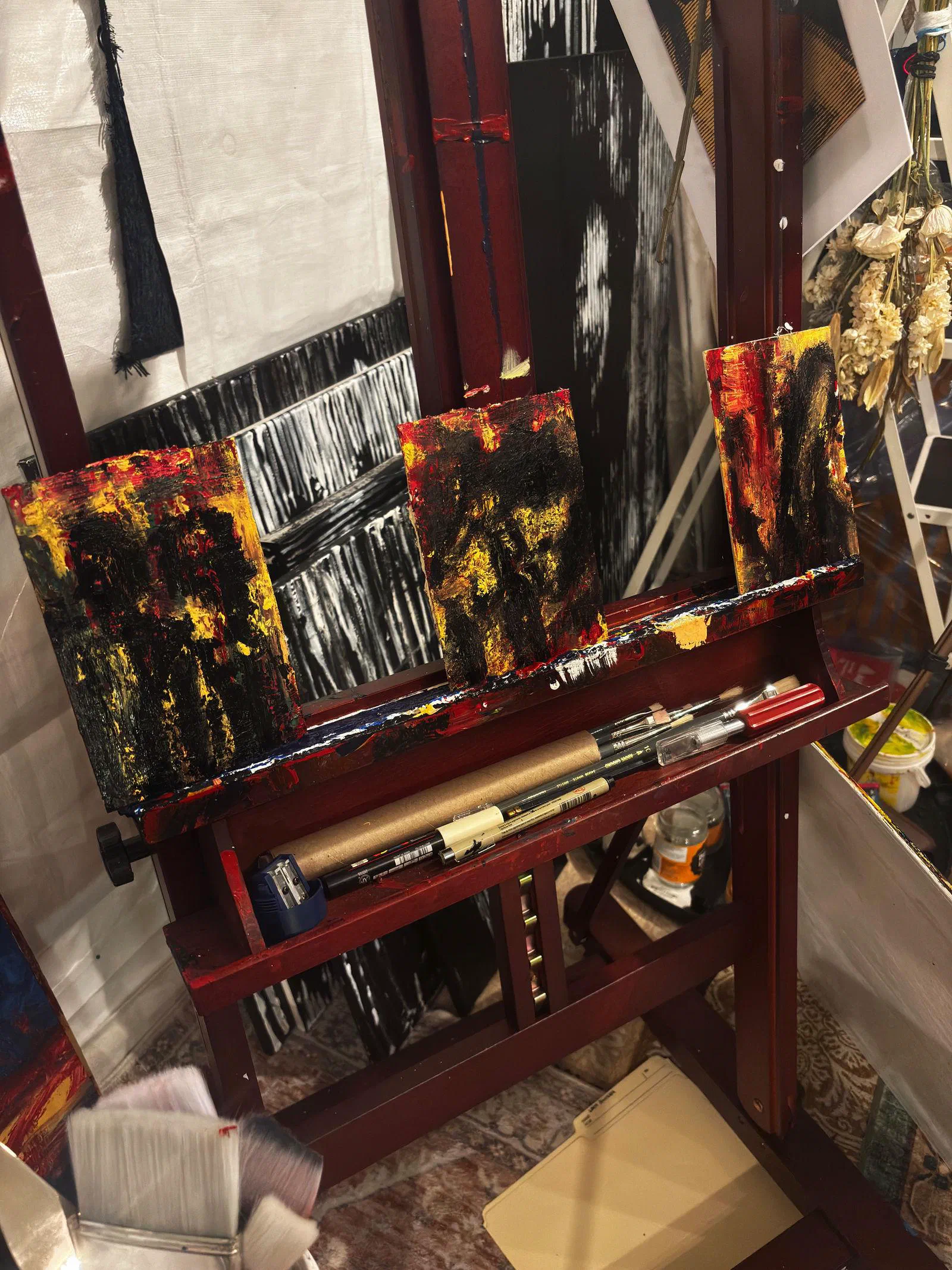 Dois Lados da Moeda, Cara and Coroa (2026), three small paintings on pressed cardboard, on the easel, April 2026.