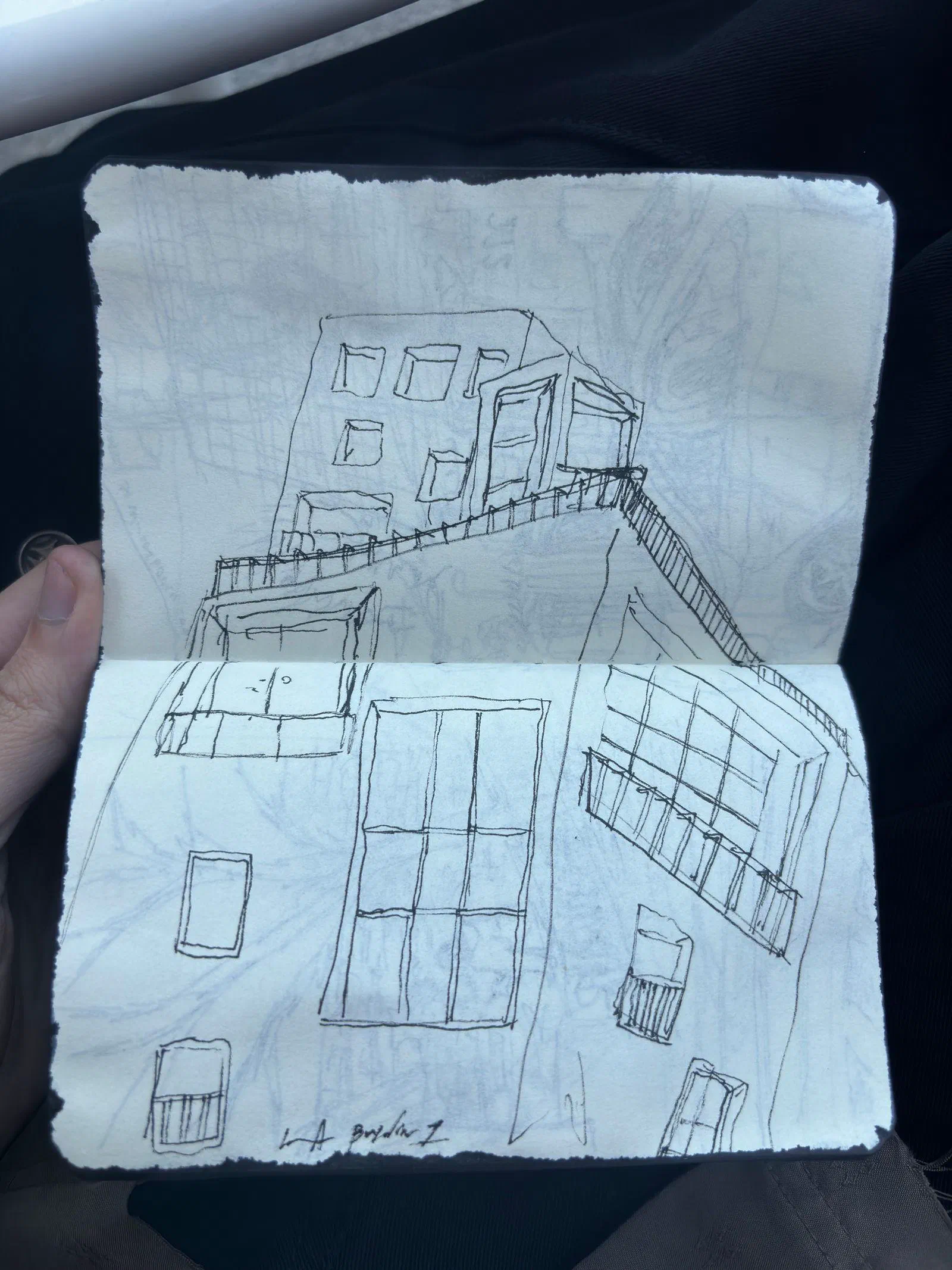 A pen drawing of a building's windows and terrace in a pocket sketchbook, July 2026.