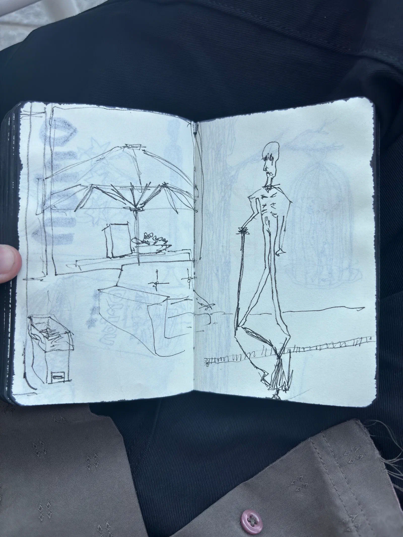 A sketchbook spread: a café table under an umbrella, and a tall, thin figure, July 2026.