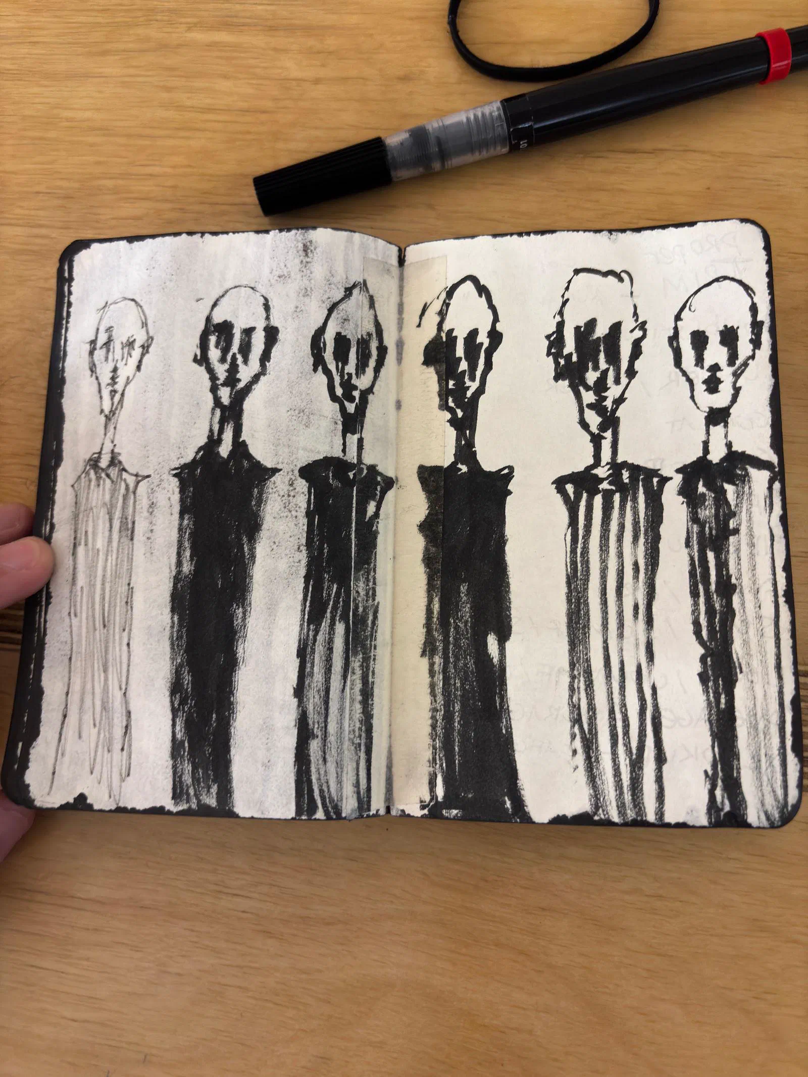 Six gaunt standing figures in black ink across a sketchbook spread, July 2026.