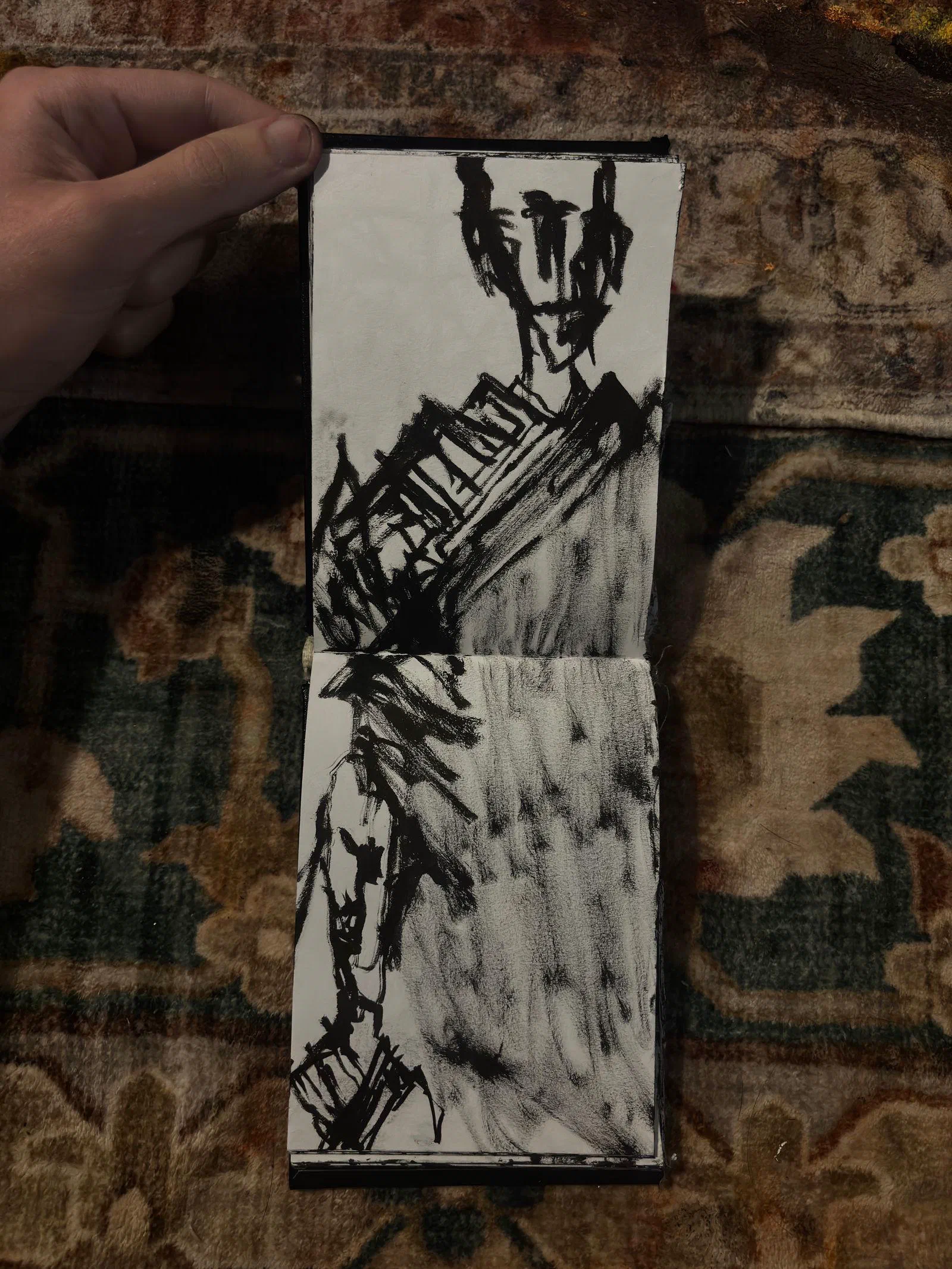 A sketchbook spread: a standing figure in heavy black strokes, August 2026.