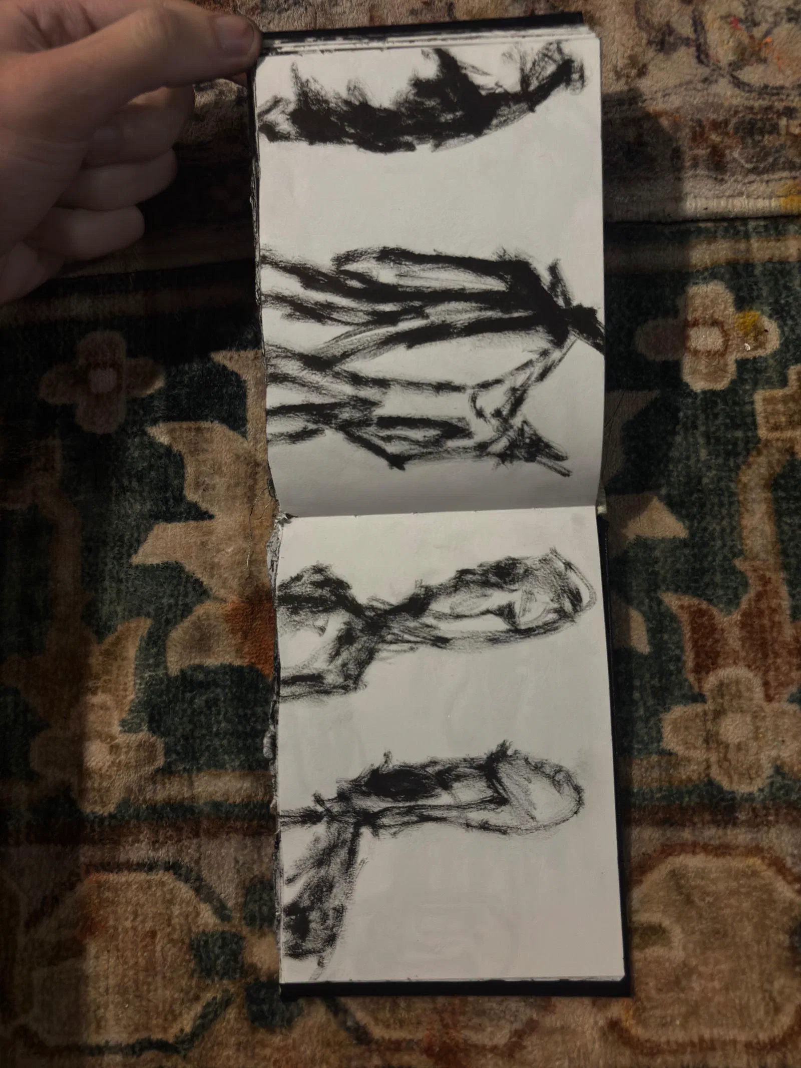 A sketchbook spread: reclining figures in loose black strokes, August 2026.